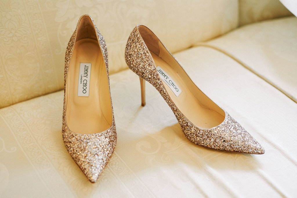 Gold Sequinned Jimmy Choo Wedding Shoes on cream sofa