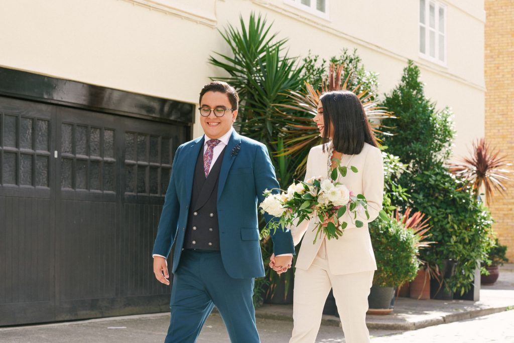 wedding couple walking together down london street