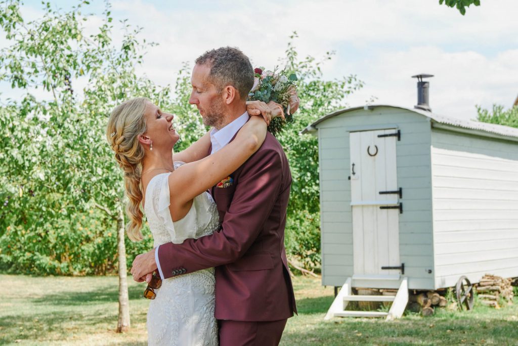 Bride and groom holding each other outside at the Almonry Barn in Somerset