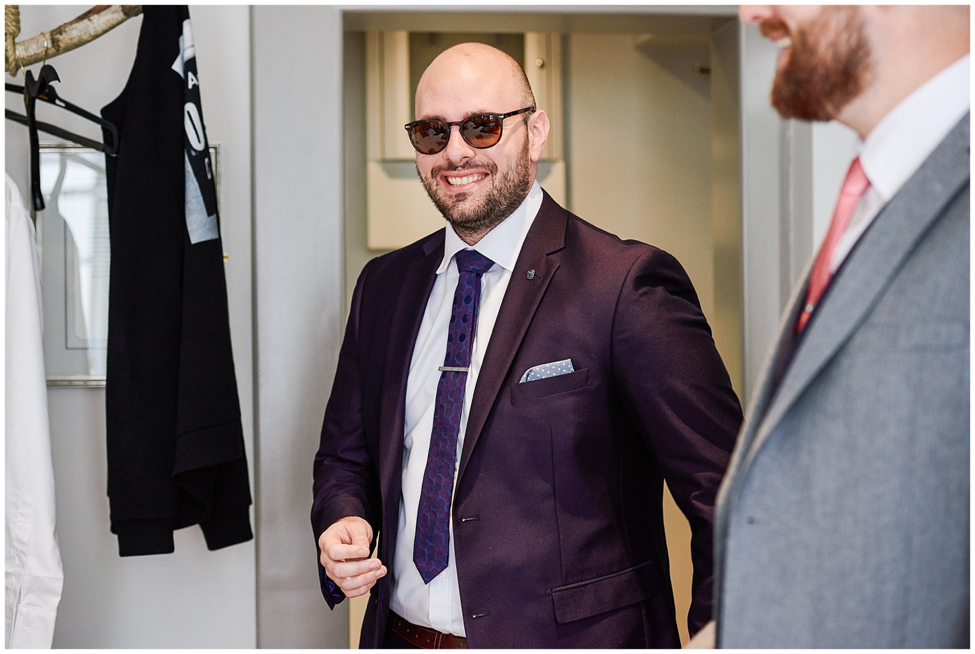 groomsman laughing in hotel room