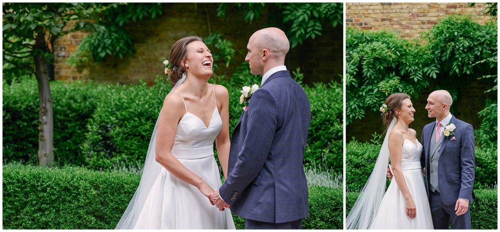 Bride and groom smiling and laughing next to green bushes and brick at Devonshire Terrace in London