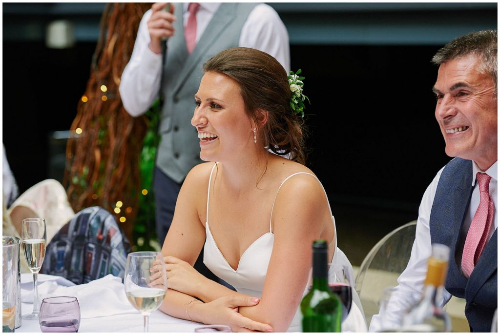 Bride laughing during wedding speeches at Devonshire Terrance in Central London