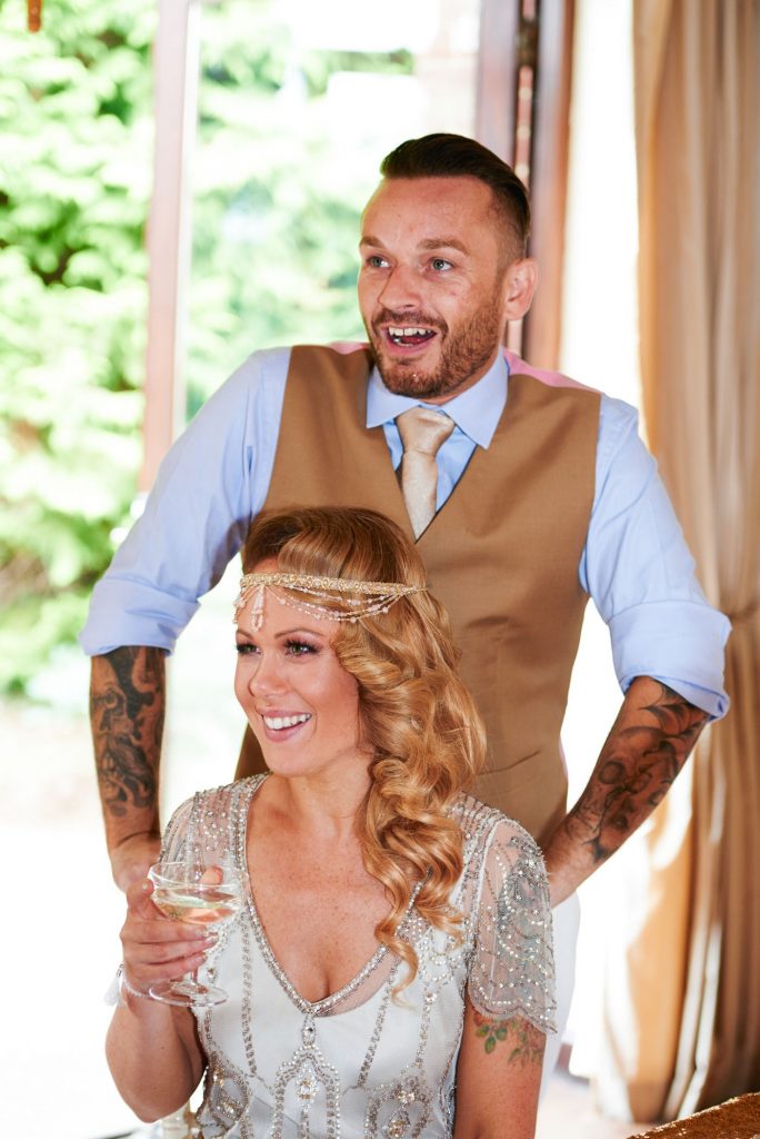 1920's style bride and groom laughing during speeches at Great Gatsby themed wedding