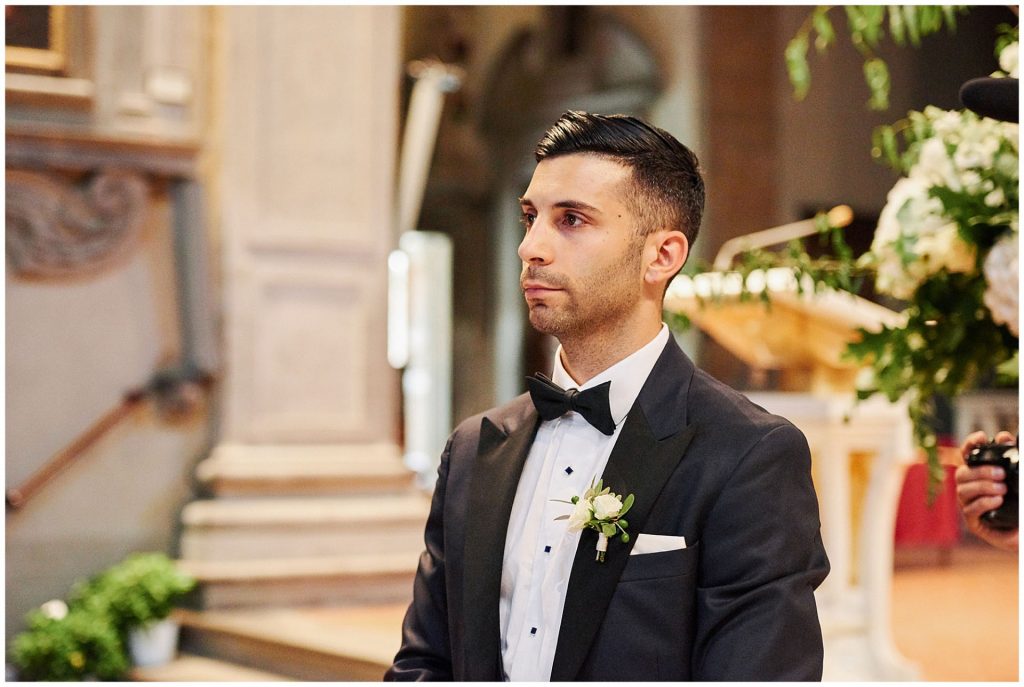 Groom waiting at the alter of Ognissanti Church in Florence, Italy