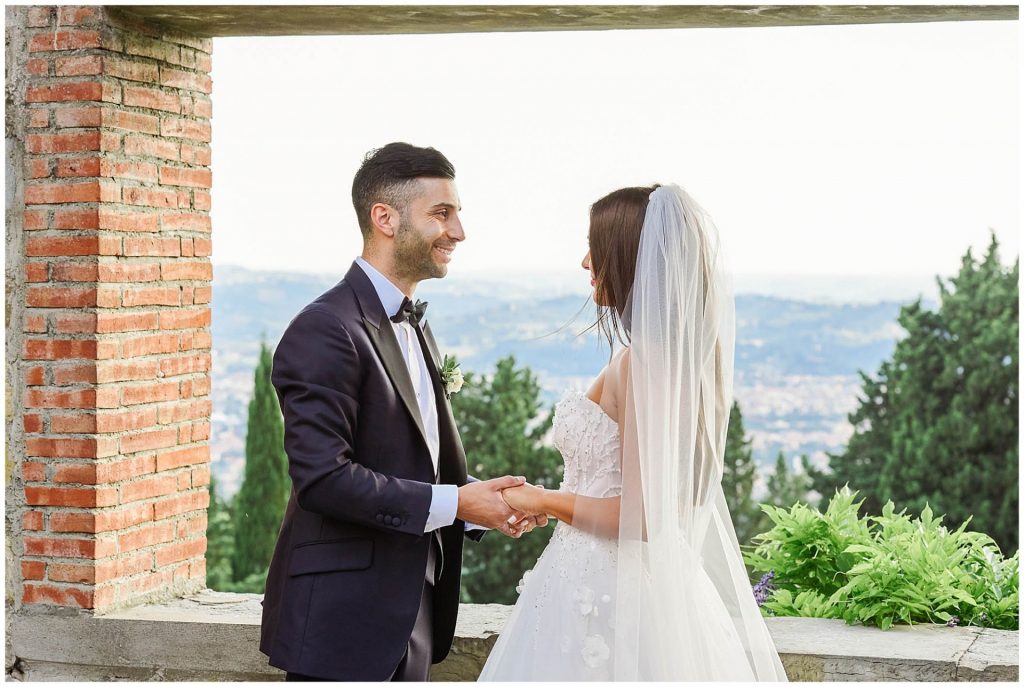 bride and groom holding hands during destination wedding at Castello Di Vincigliata