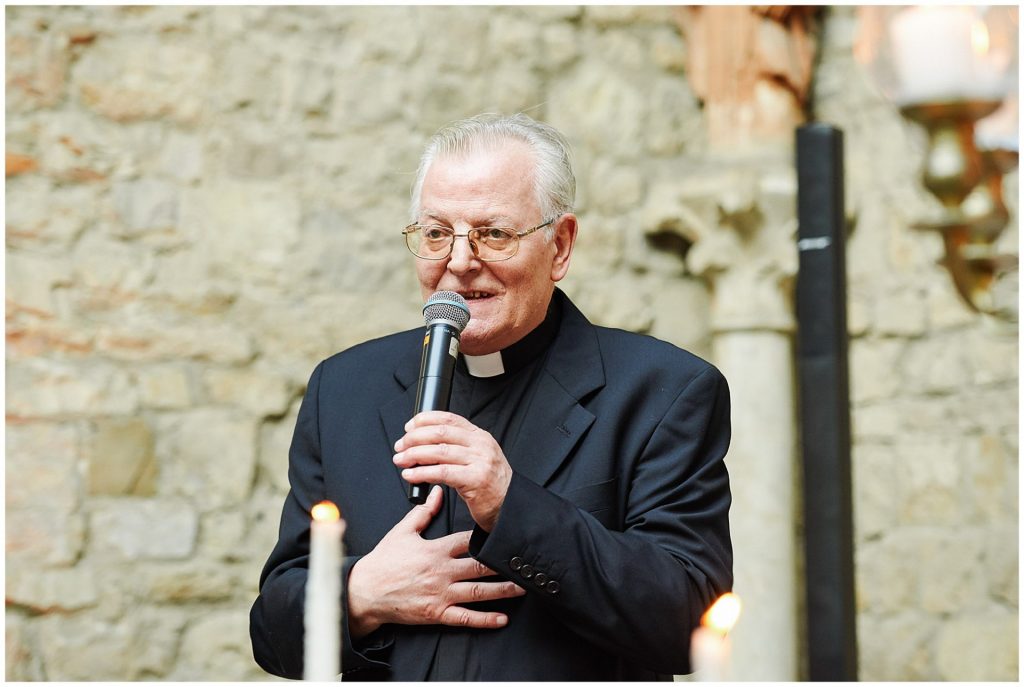 Priest giving a speech during Florence destination wedding at Castello Di Vincigliata