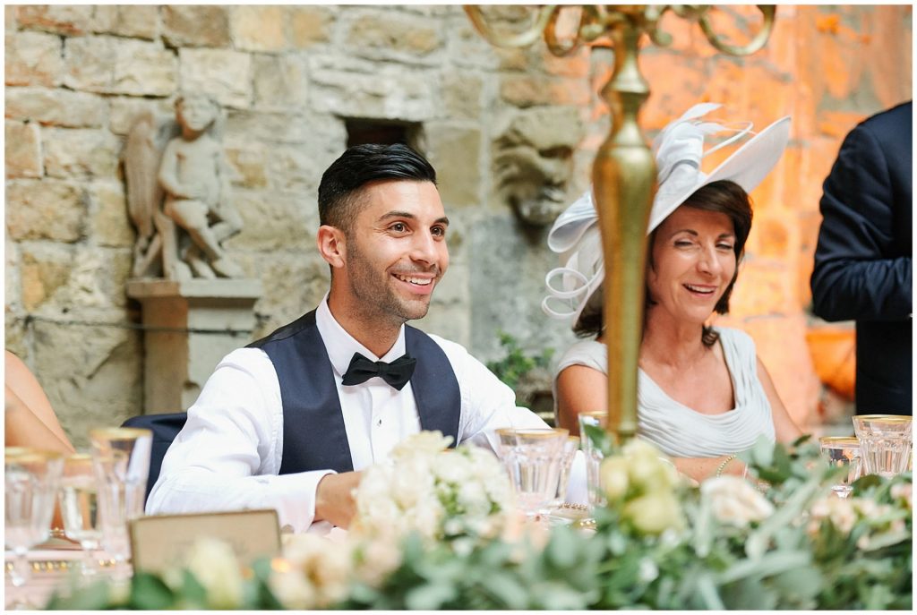 Groom laughing during speeches at Castello Di Vincigliata destination wedding