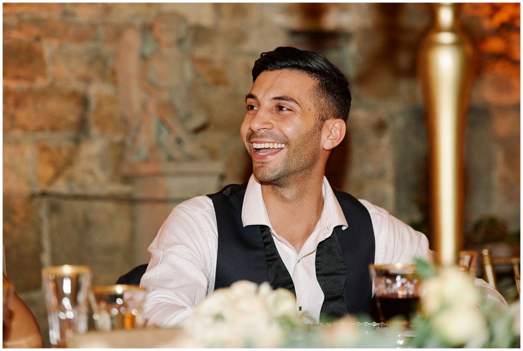 Groom laughing during speeches at Castello Di Vincigliata