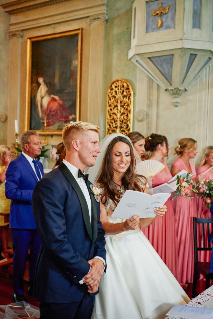 Bride and groom laughing during their wedding ceremony at the Catholic Church of Careggi in Florence, Italy 