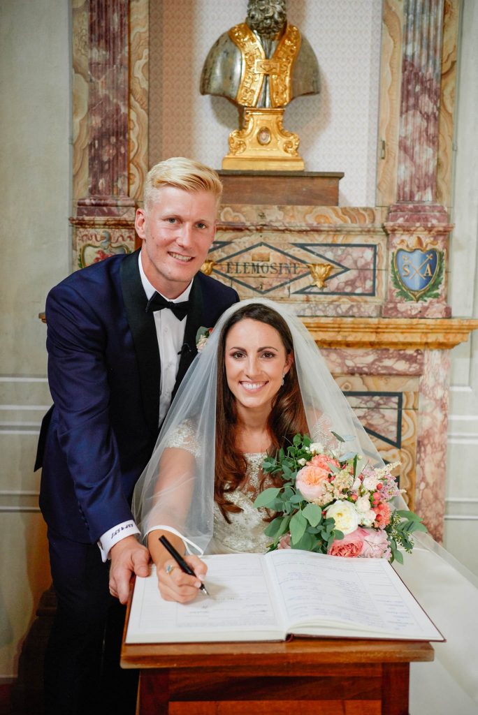 Bride and groom signing the register at the Catholic Church of Careggi in Florence, Italy