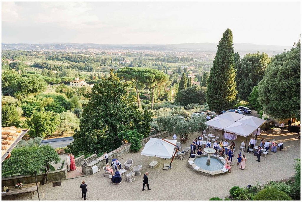 Stunning tuscan landscape featuring guests relaxing and socailising at the villa le Fontanelle wedding venue in Florence, Italy