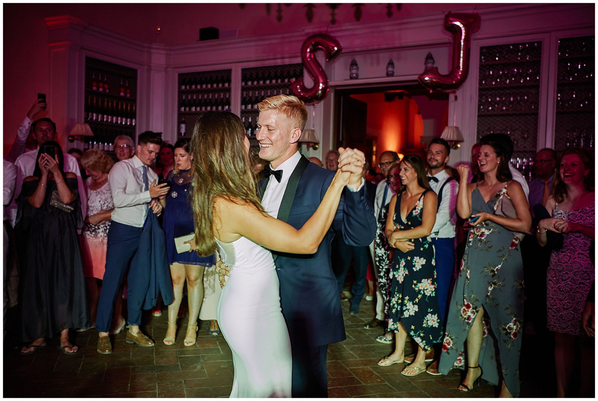 Bride and groom during first dance together with family and friends watching at Villa le Fontanelle in Florence