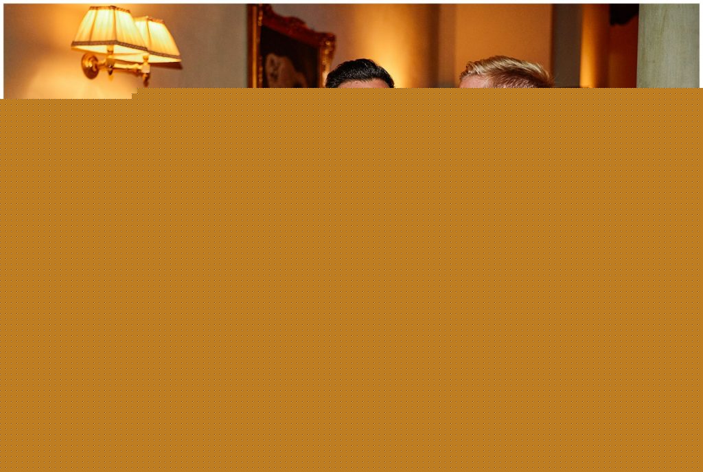 Groom and best man at the end of the night with drinks and ties undone at Villa le Fontanelle in Florence, Italy.