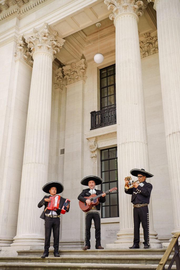 Mexican mariachi band playing outside of The Old Marylebone Town Hall on wedding day 