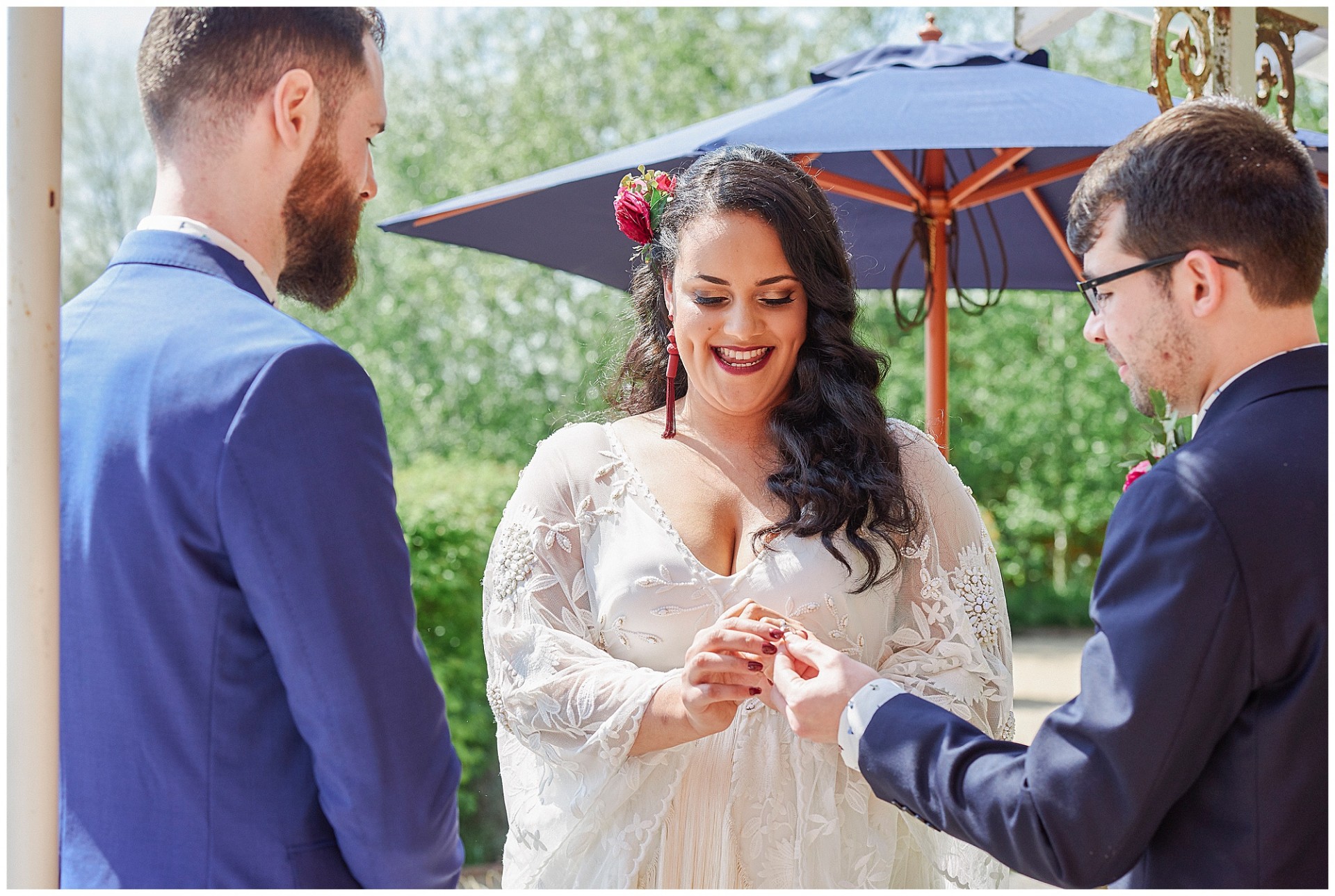 Bride taking the ring during outdoor wedding ceremony at the Walled Garden in Nottingham.