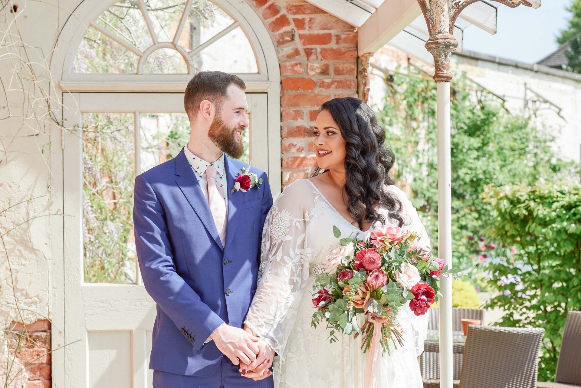 Bohemian bride and groom stood outside at the beautiful Walled Garden in Beeston, Nottingham.