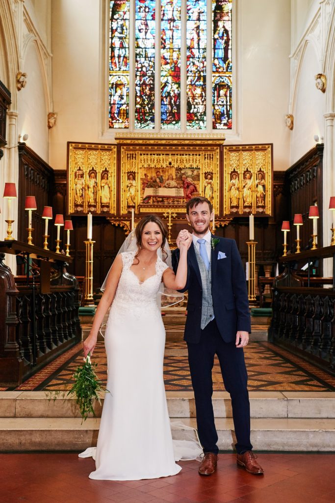 Bride and groom smiling together after getting married in St Margret's Church in London 