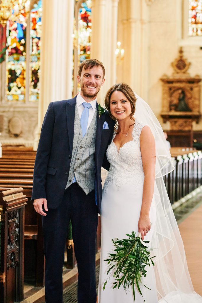 Bride and groom smiling together after getting married in St Margret's Church in London 