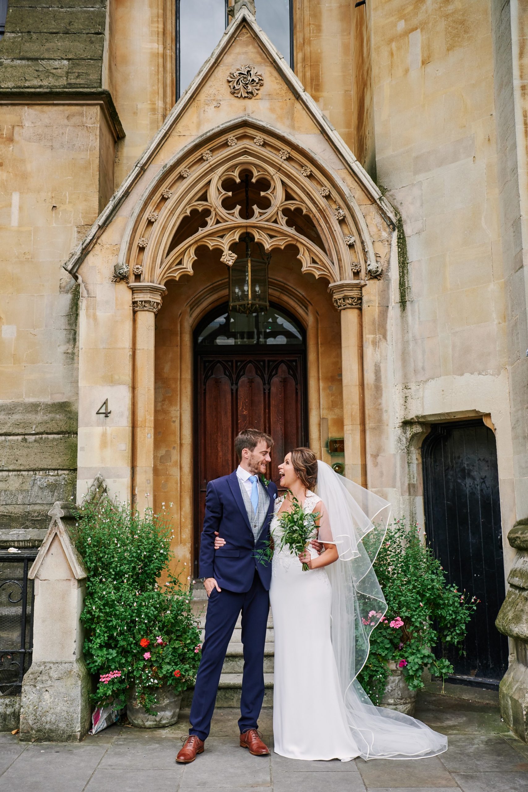 Riverside-City-Wedding-at-the-Oyster-Shed-in-Central-London-088 Bride and groom smiling together outside of an old doorway in London
