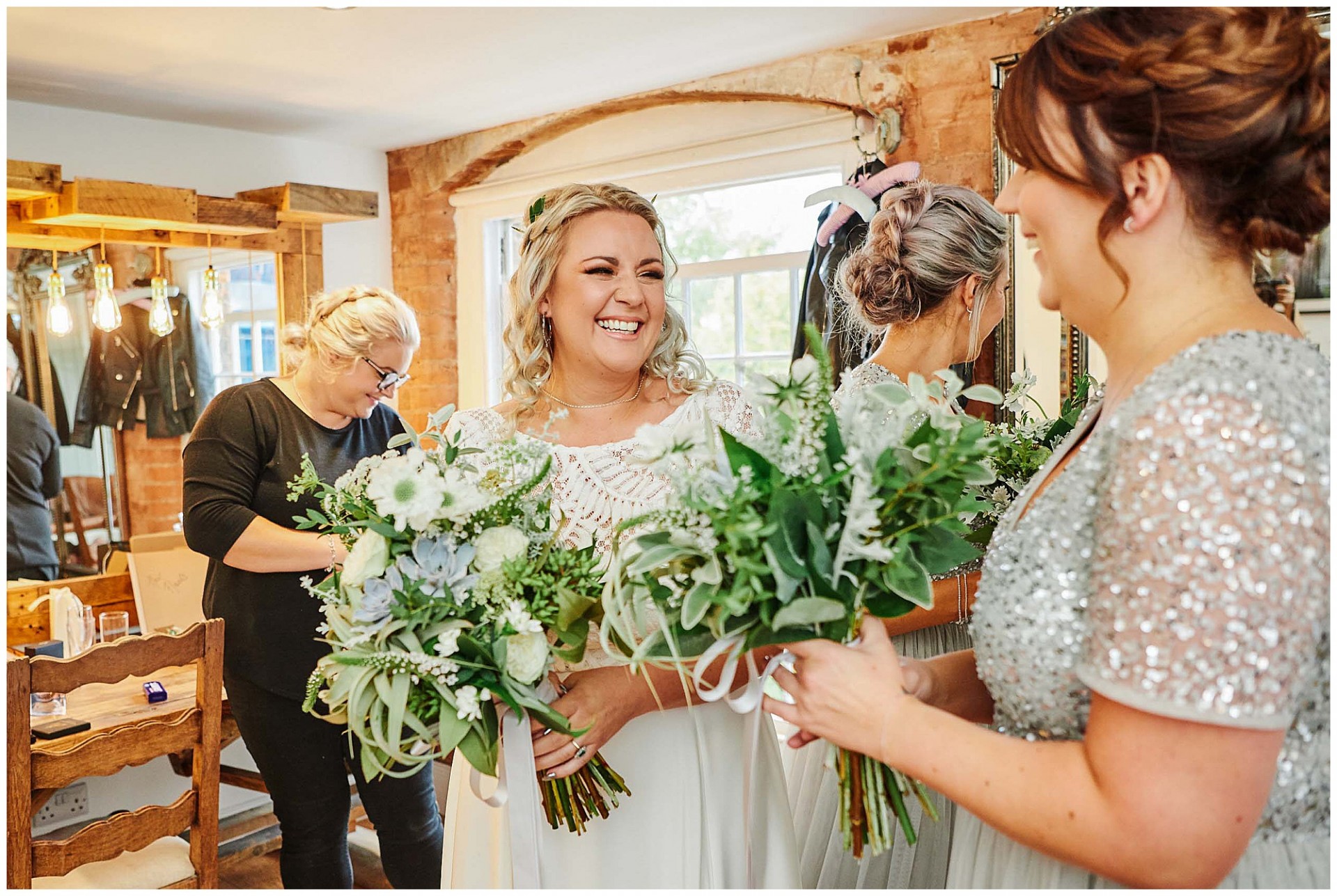 Bride laughing and holding flowers  at The West Mill Wedding Venue in Derby