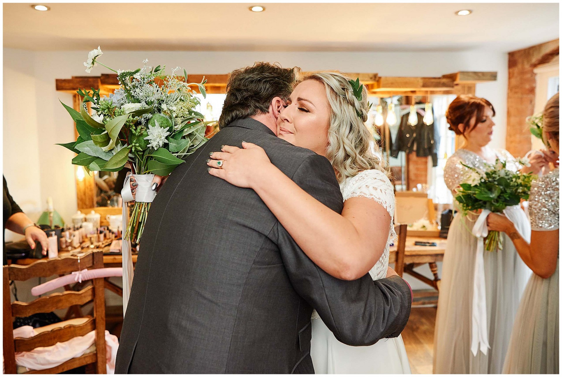 Bride hugging father of the bride at The West Mill Wedding Venue in Derby