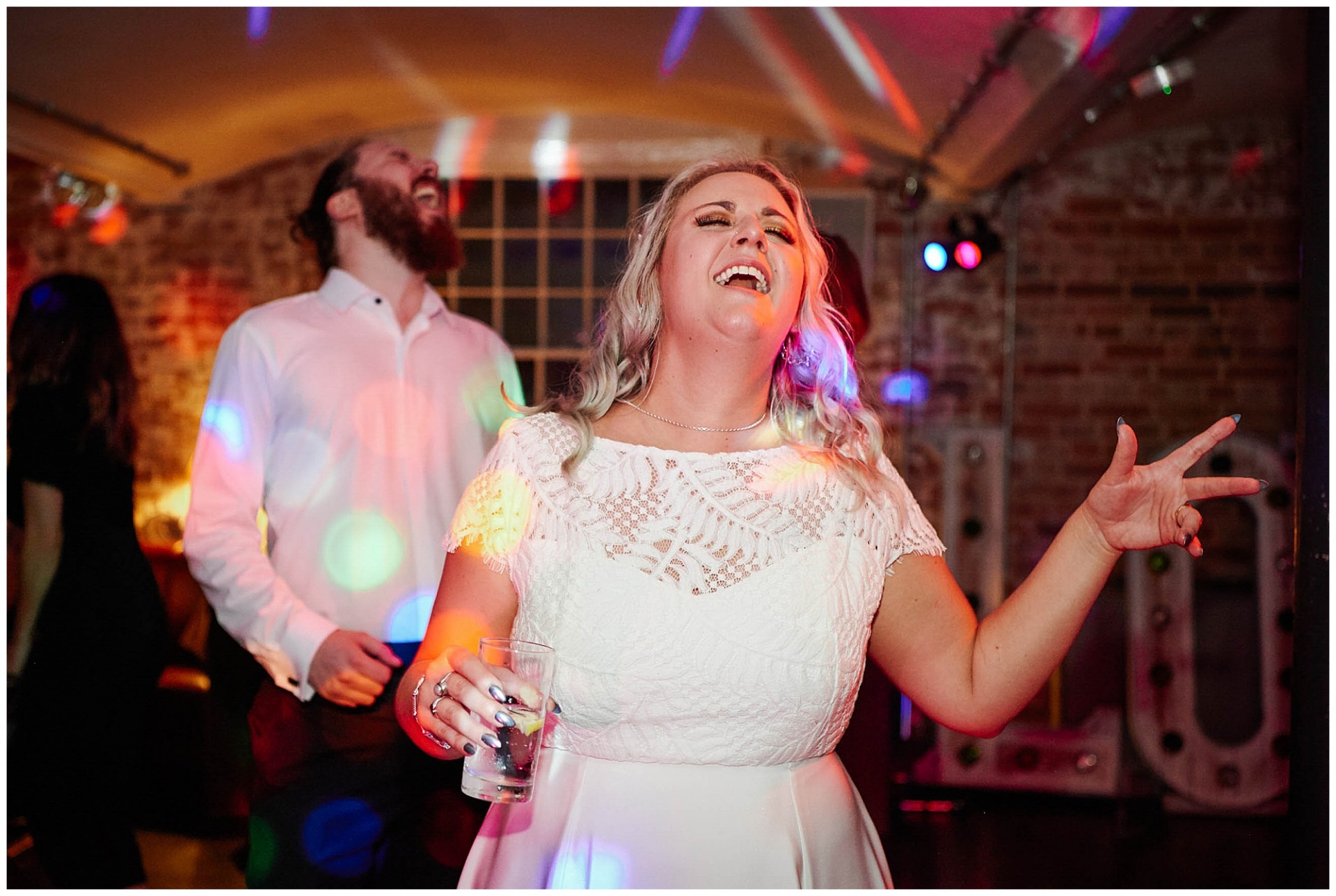 Bride singing and dancing during the evening reception at The West Mill Wedding Venue in Derby.