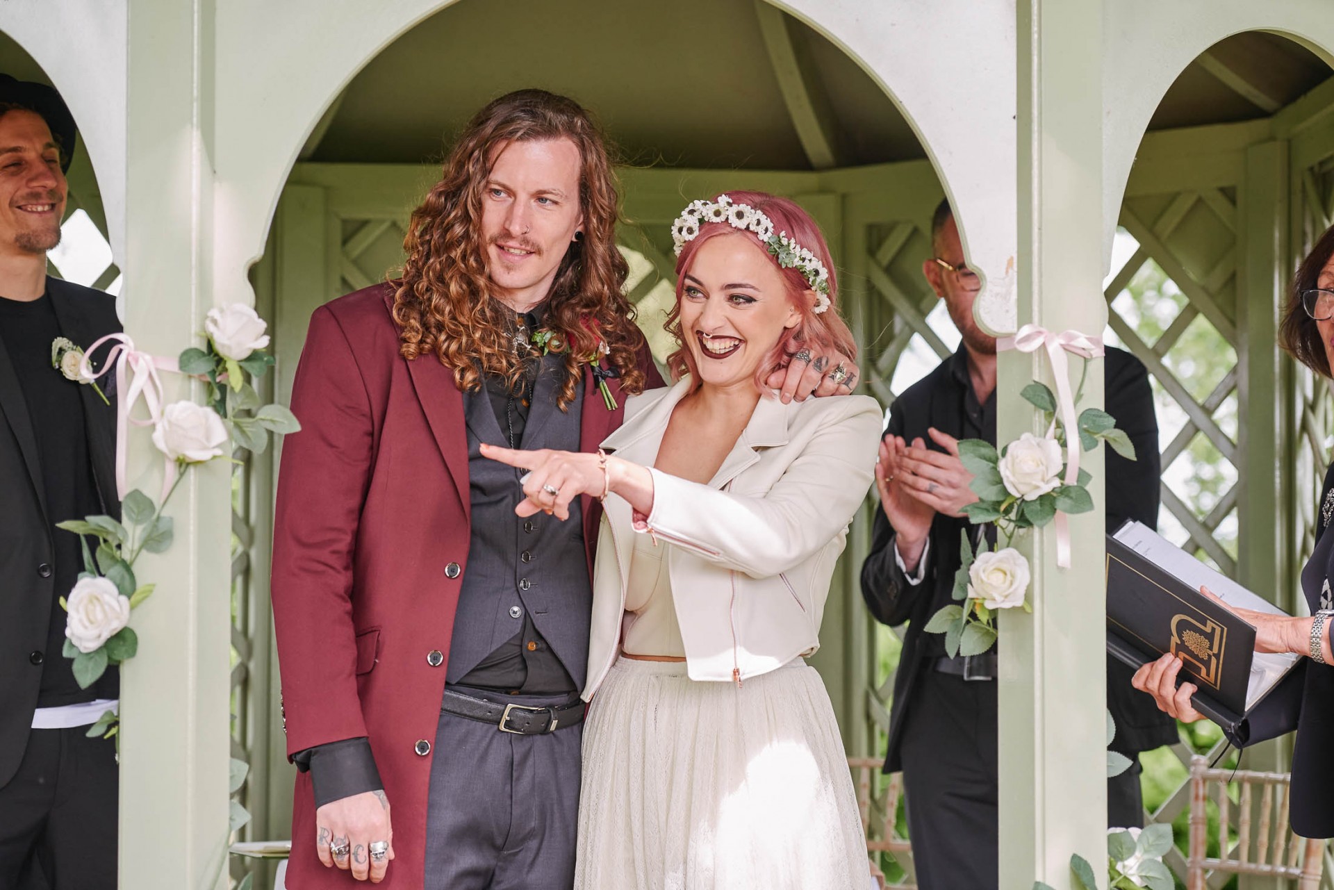 Rock n roll bride and groom smiling during outdoor wedding ceremony at The Pheasantry Brewery.