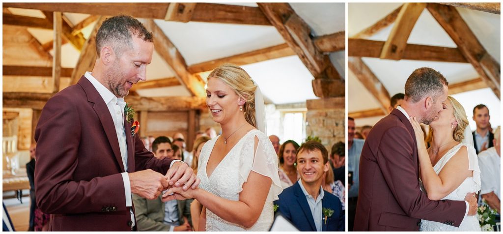 bride and groom exchanging rings during their barn wedding ceremony