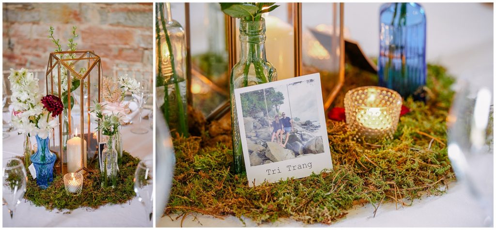 The Almonry Barn festival wedding table with polaroids, moss and candle details