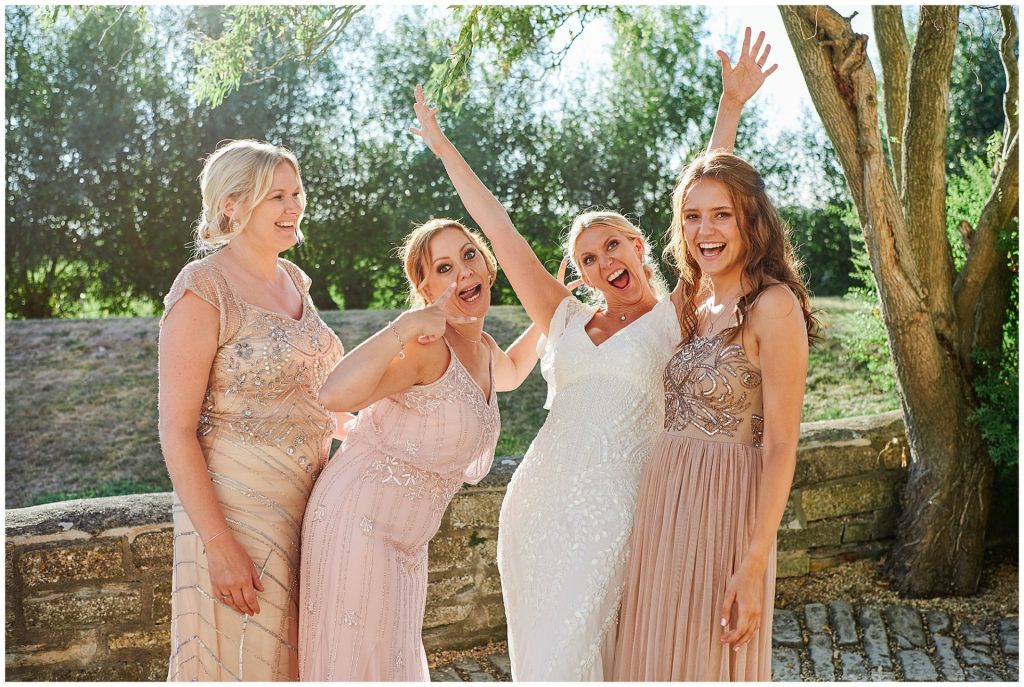 Fun bride with her bridesmaids during summer festival wedding
