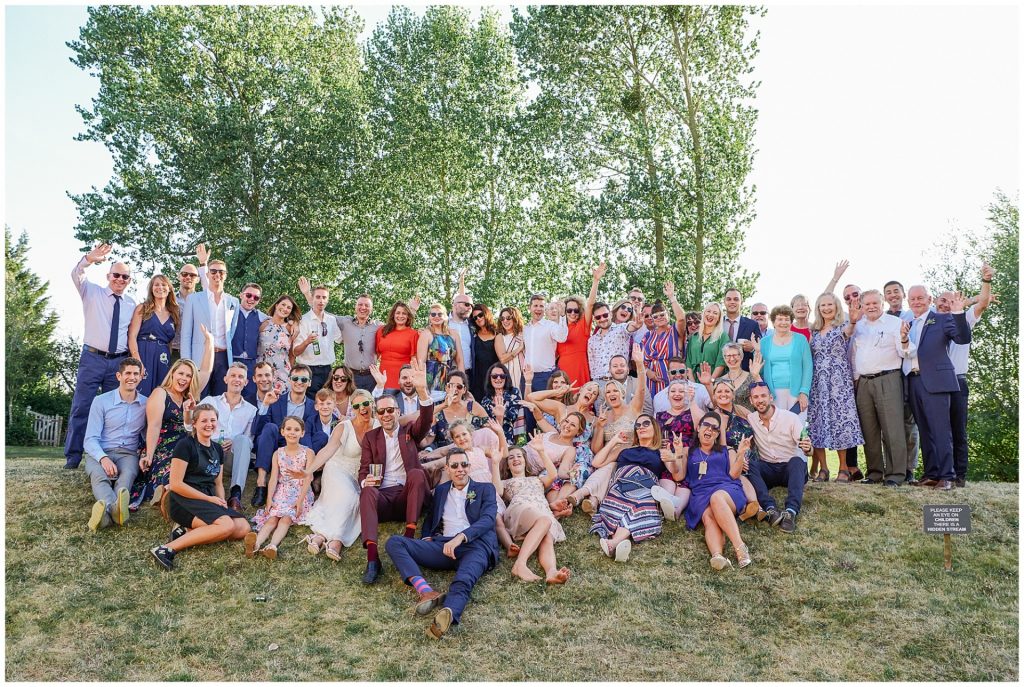 Group wedding party shot during outside summer festival wedding