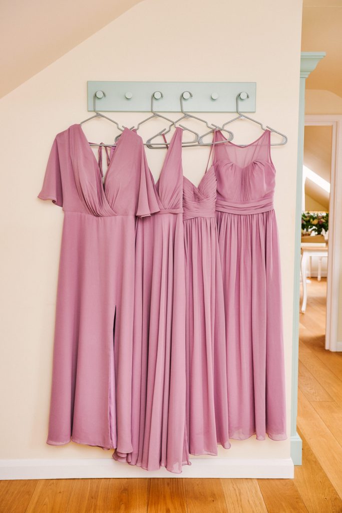 Lilac coloured bridesmaids dresses hung up in a row