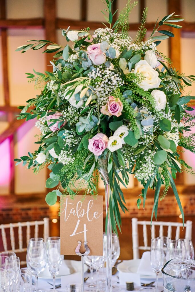 Wedding flowers on dinner table with table number details
