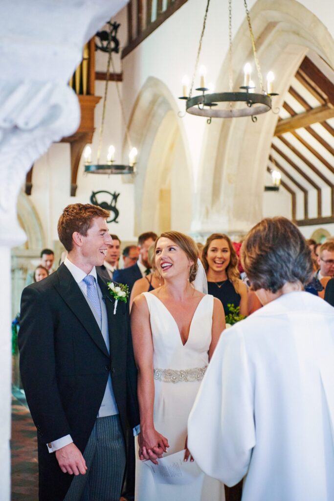 bride and groom smiling at each other during wedding ceremony
