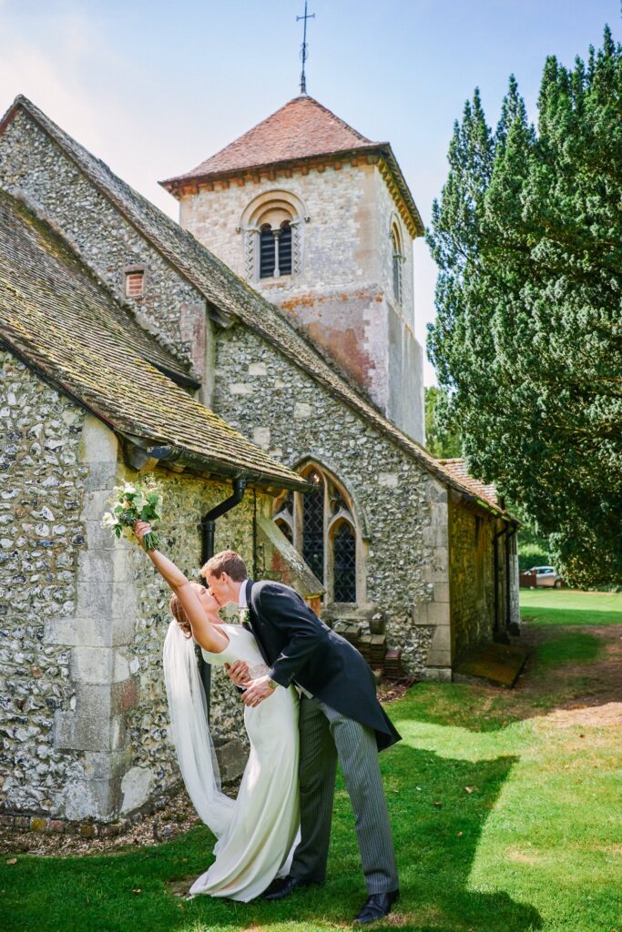 bride and groom celebrating outside of a church after their wedding ceremony