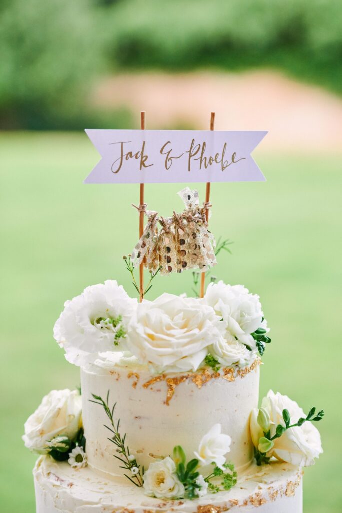 beautiful white rose wedding cake at a summer festival wedding 