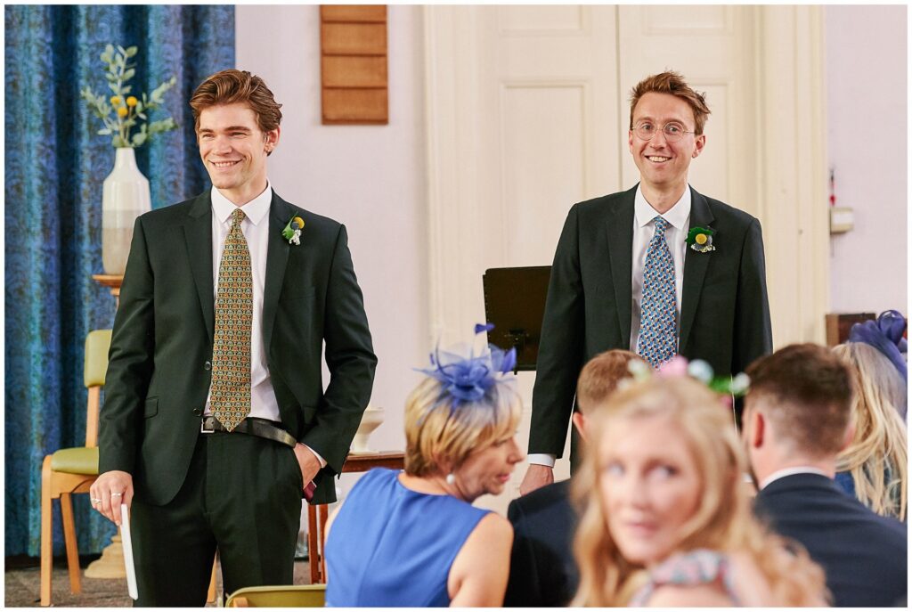 Groom and Usher smiling at the alter  at Brighton Unitarian Church