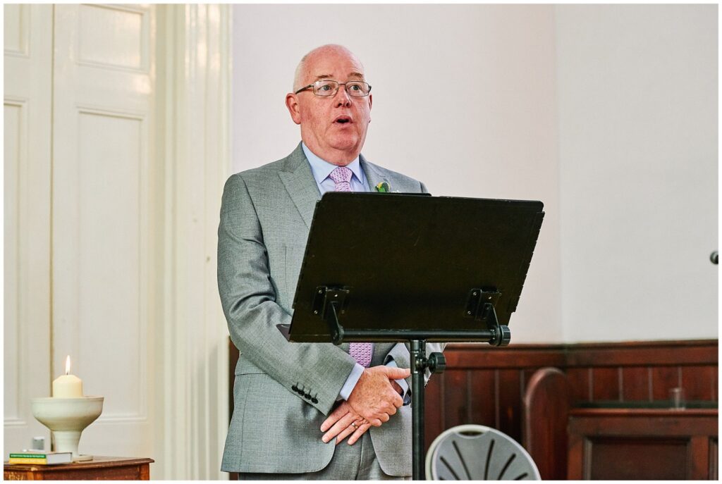 wedding guest giving a reading  during ceremony at Brighton Unitarian Church