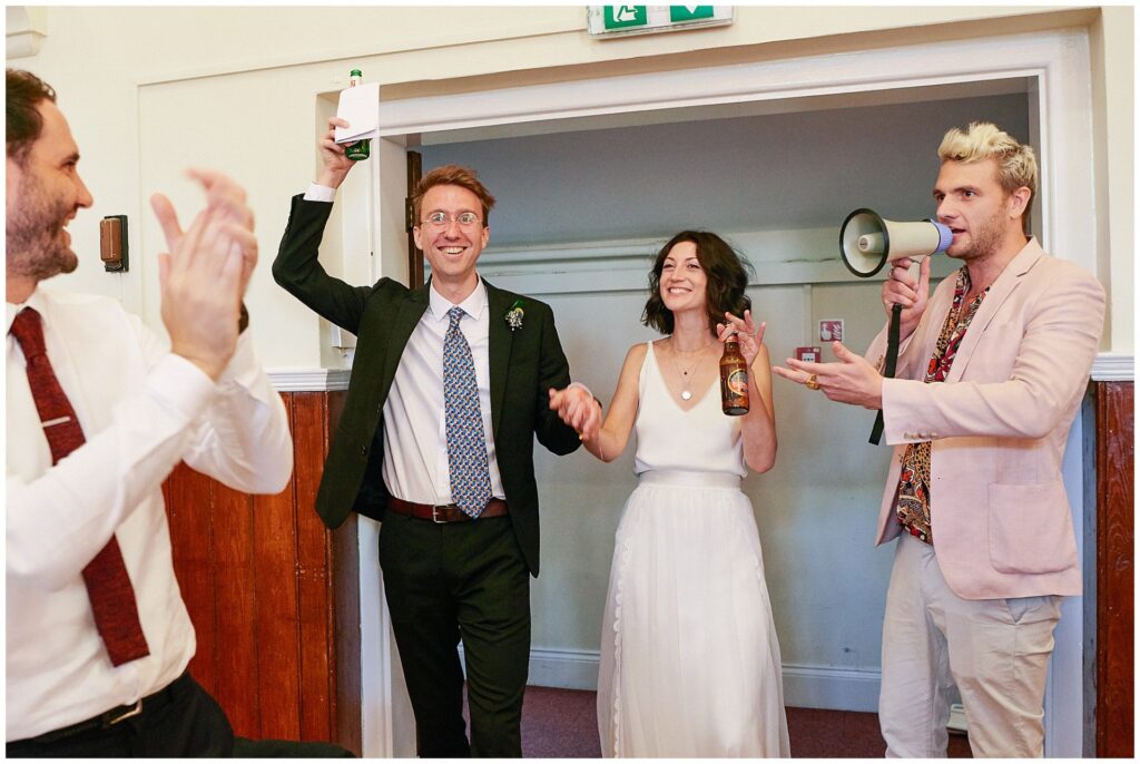 Bride and Groom entering their wedding reception at Queens Hall in Cuckfield