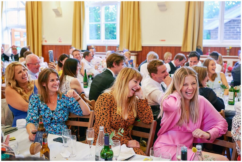 Wedding guests laughing during speeches at a laid back Brighton wedding 