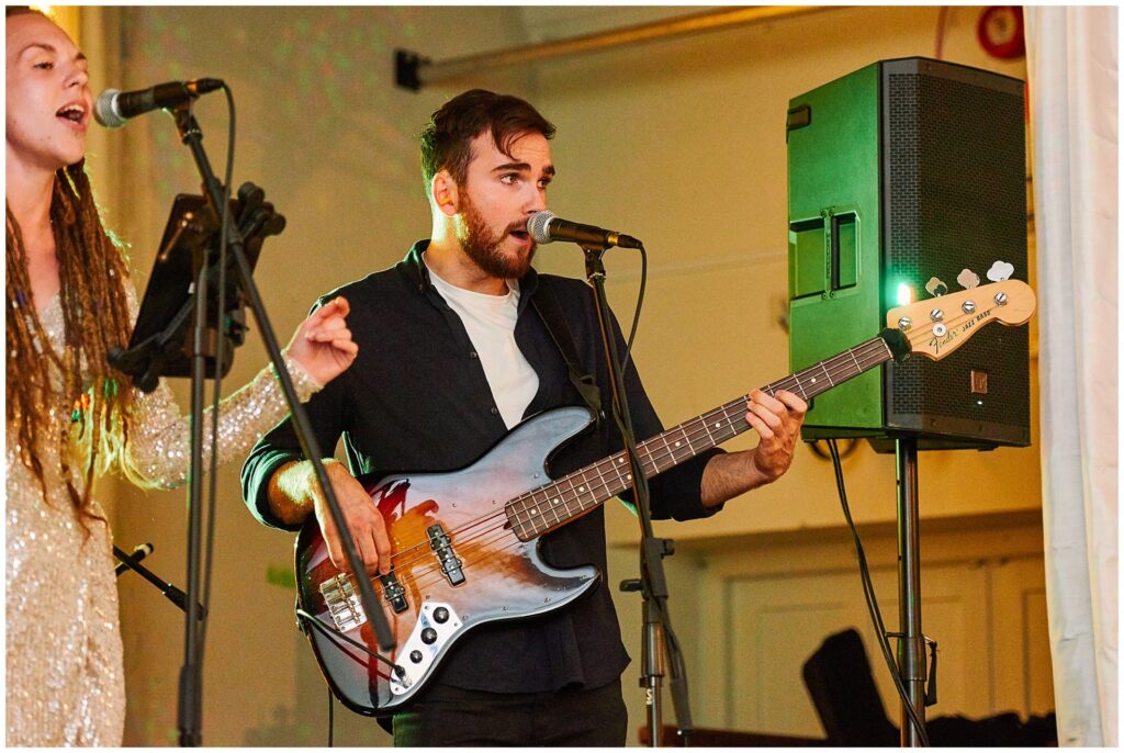 Musician playing guitar at wedding reception in Brighton 
