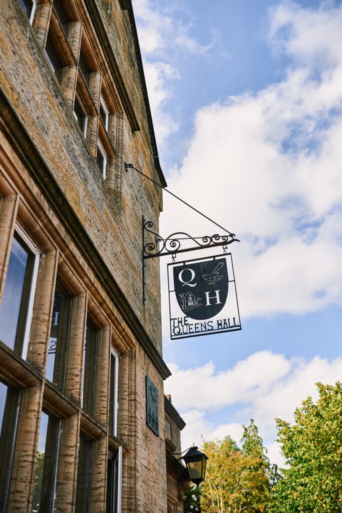 Queen's Hall sign on brick building in Cuckfield 