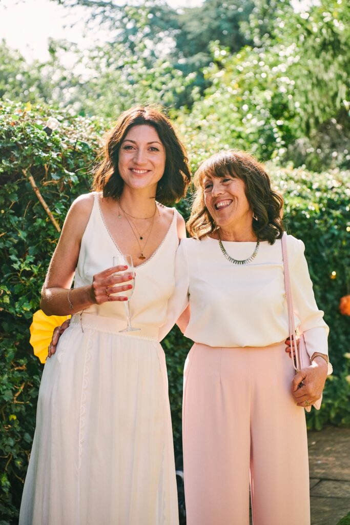 Bride with her mum on summers day during wedding garden party