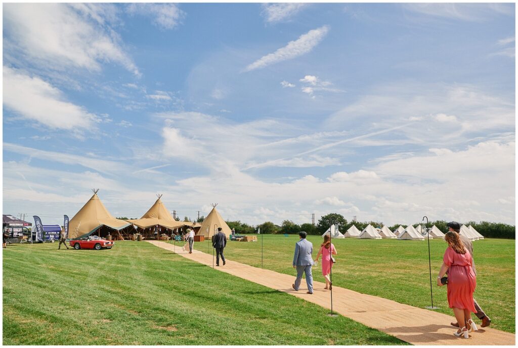 Guests arriving at relaxed festival tipi wedding in Essex