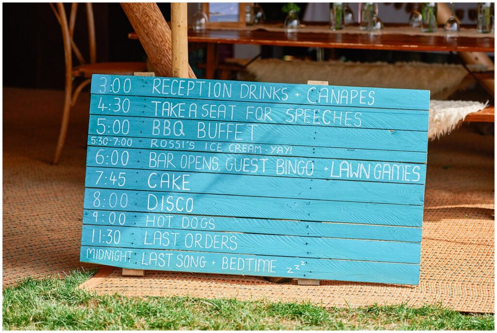 wedding order of the day sign printed on a rustic wooden crate