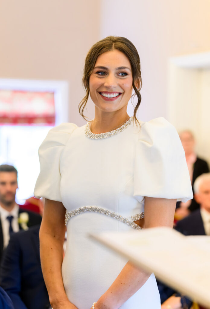 Bride smiling during her West Bridgford Registry Office wedding ceremony