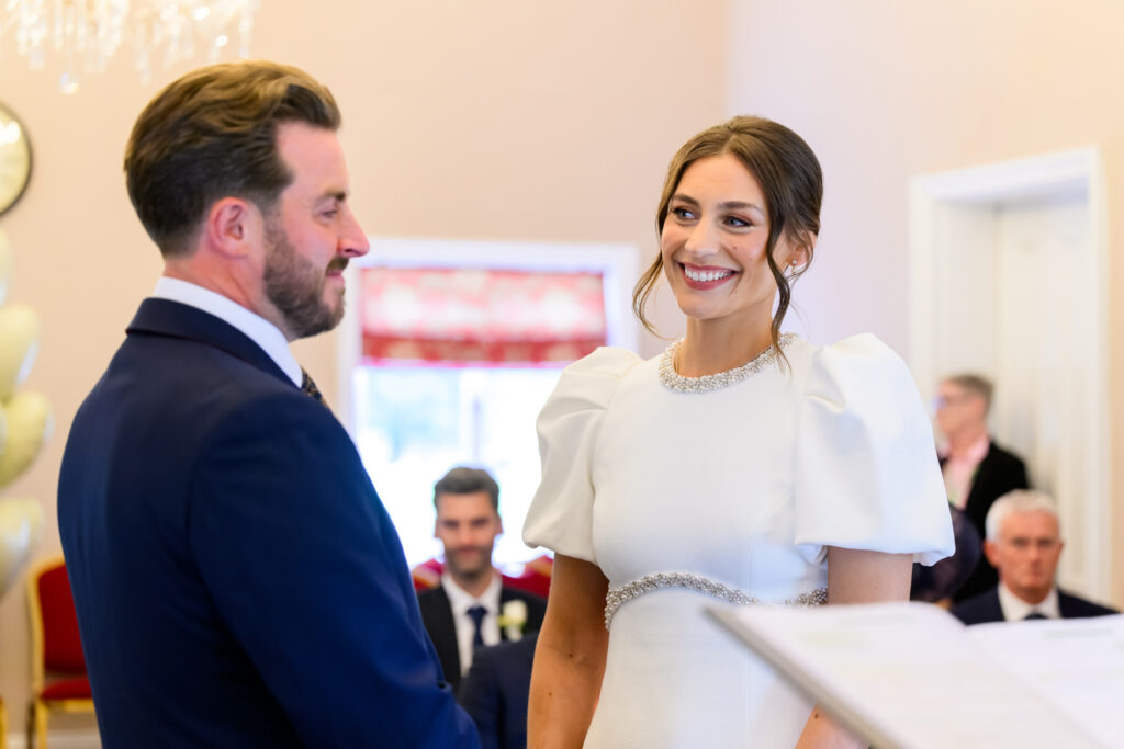 Bride and groom exchanging vows at West Bridgford Registry Office