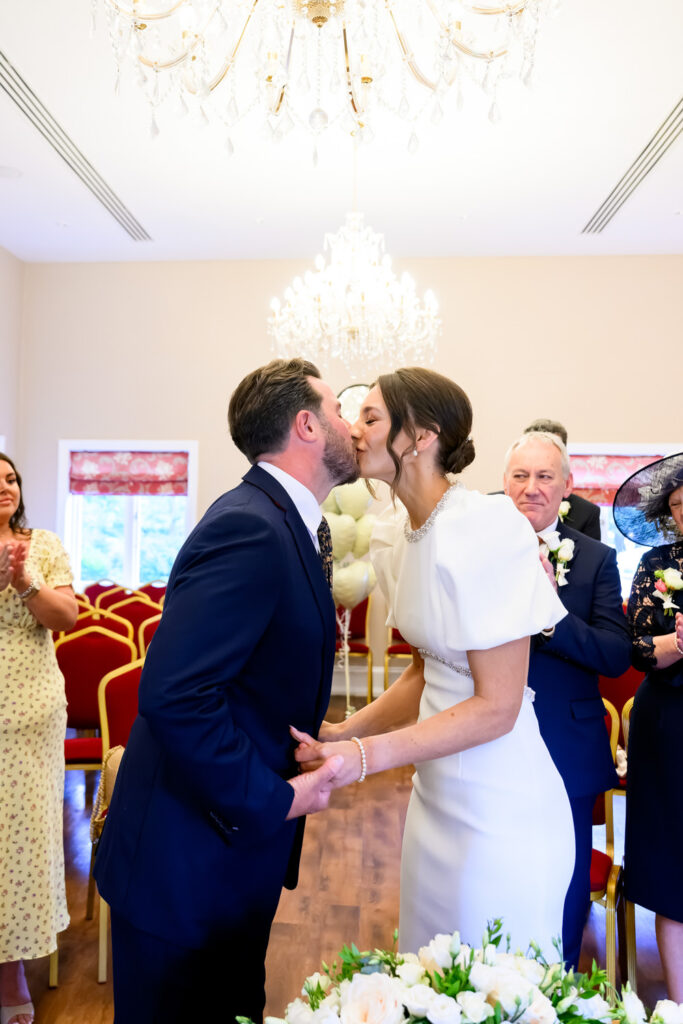 Bride and groom sharing their first kiss at West Bridgford Registry Office
