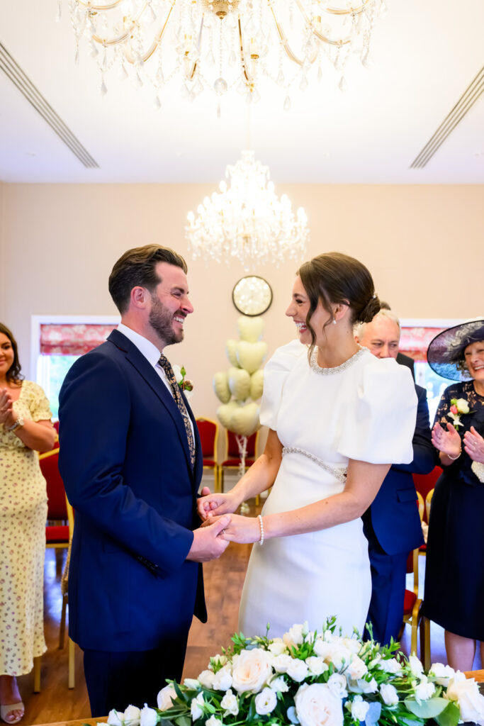 Newly married couple smiling during their Registry Office ceremony