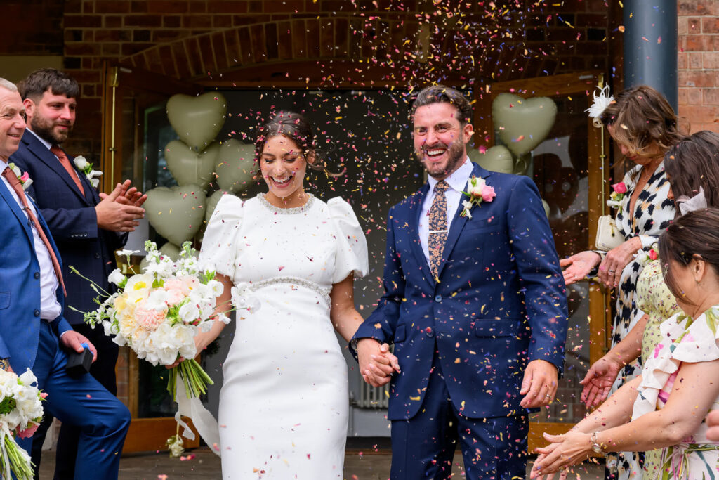 Newly married couple celebrating with confetti outside West Bridgford Registry Office